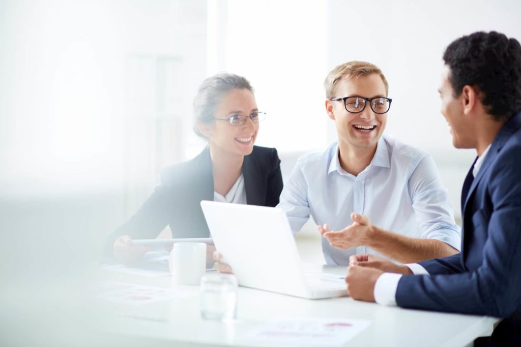 Portrait of smart business partners communicating at meeting